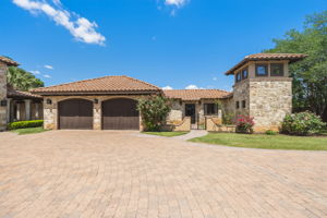 One of two detached two-car garages which are insulated with dedicated HVAC .  See the private entry gate to the  guest villa between the garage and the tower.