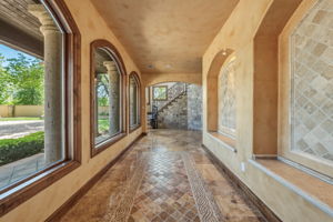 As you open the exquisite wrought iron doors, decorative granite floors grace the foyer with large windows.