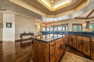 The spacious kitchen features knotty alder cabinetry, dark granite countertops with a cooktop.  Big Windows provide great views.