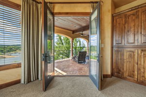 Primary Bedroom french doors open to the covered porch.