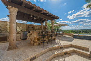 Outdoor living at its best with a full kitchen, granite counters, and spectacular waterfront views.