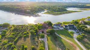 Aerial view showcasing the property advantageous position with  water view, surrounded by green hills.