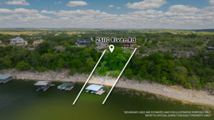 This property features extensive waterfront land with lush trees and a boat dock.