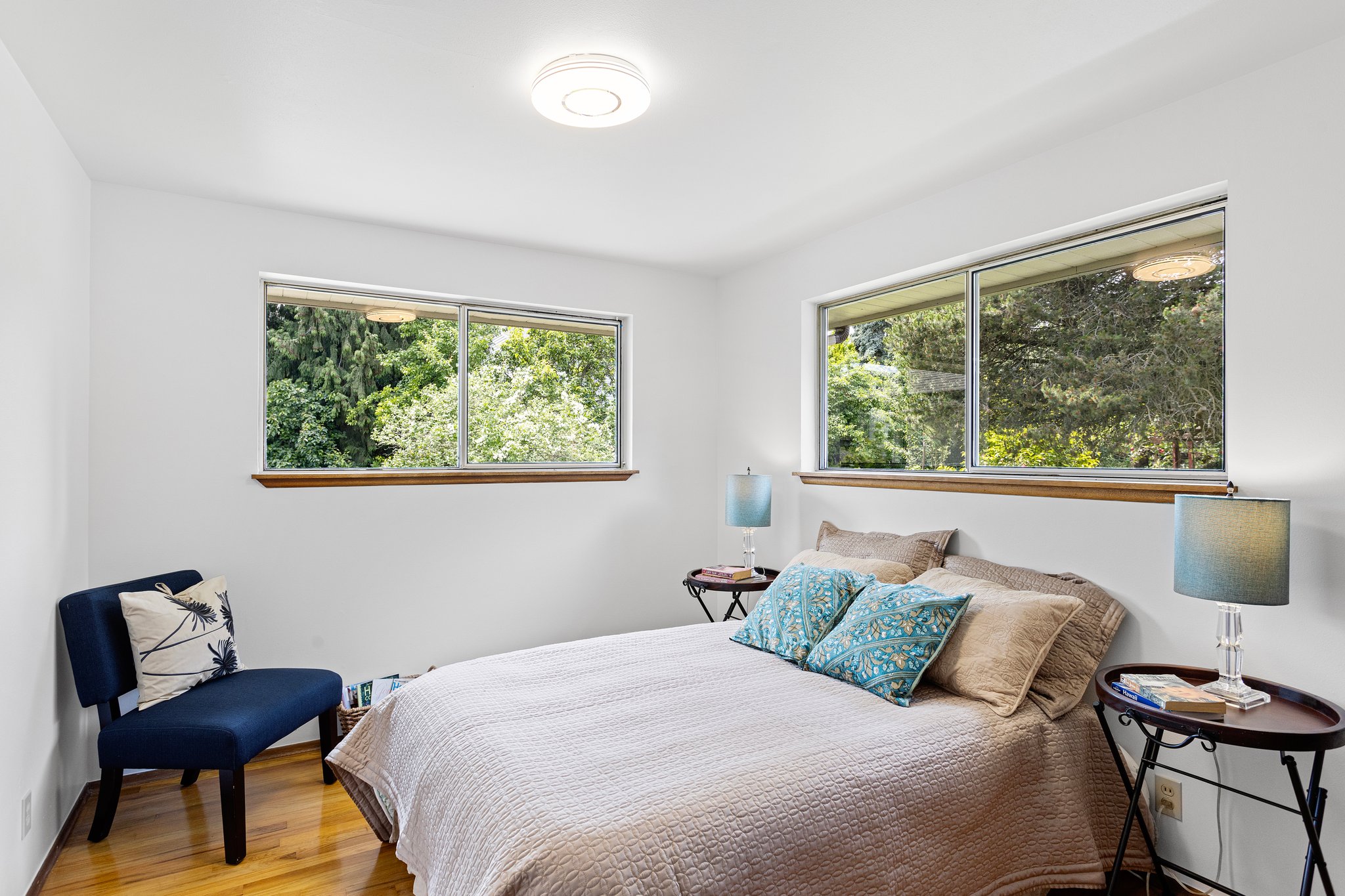 The southwest bedroom is the brightest of the bunch, with windows to the south and west, and a lush green view of the backyard.
