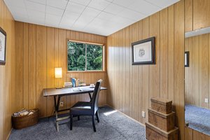The fourth bedroom is a permitted and inspected addition from 1974. It can be used as a flex space for various purposes, such as an office, study, or storage. It has a large closet for extra storage and is located near the back deck.