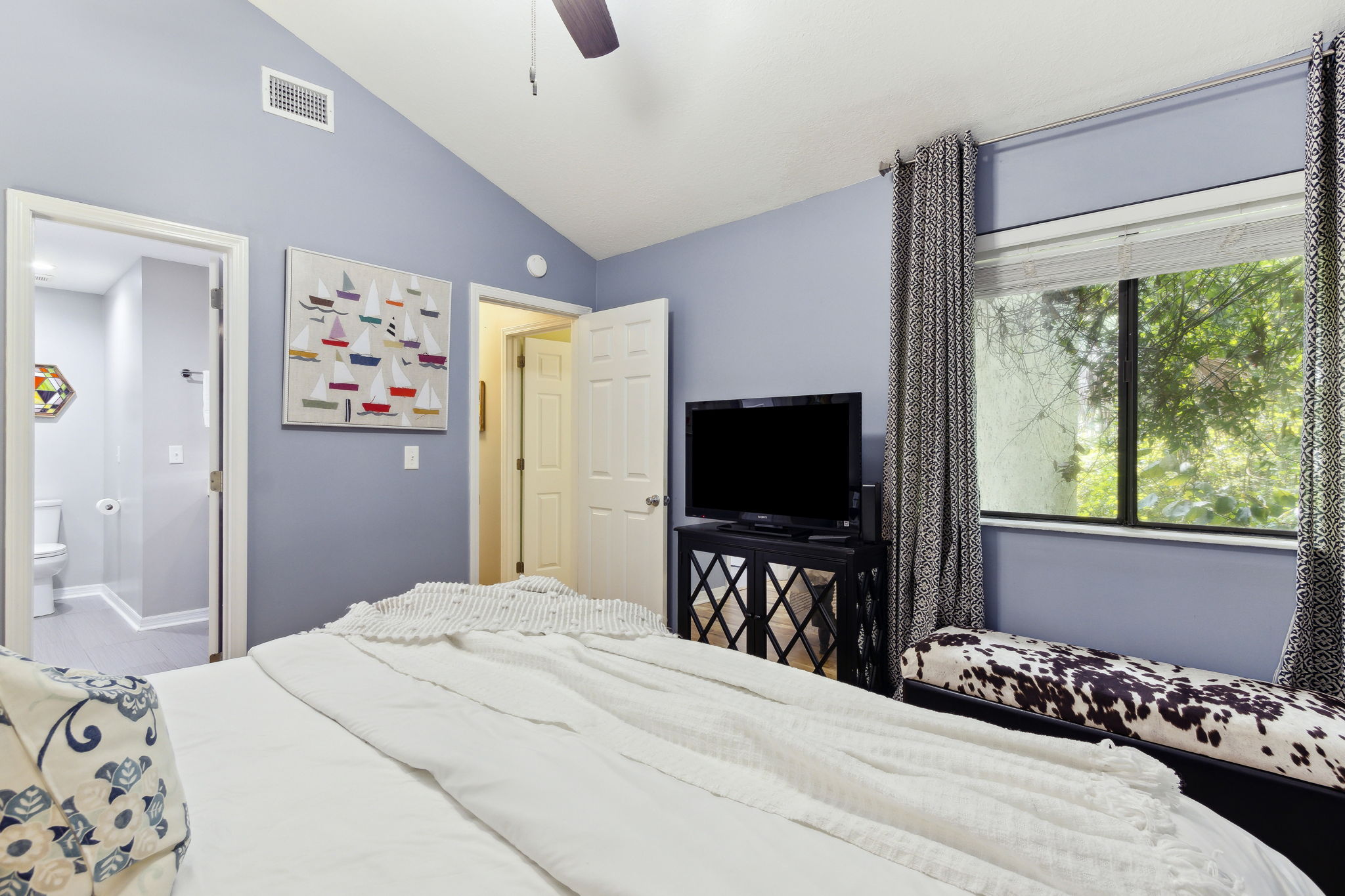 Vaulted ceilings and double windows create a bright, open space