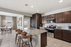 Open Concept Kitchen and Dining Room.  Curtains/Art virtually staged