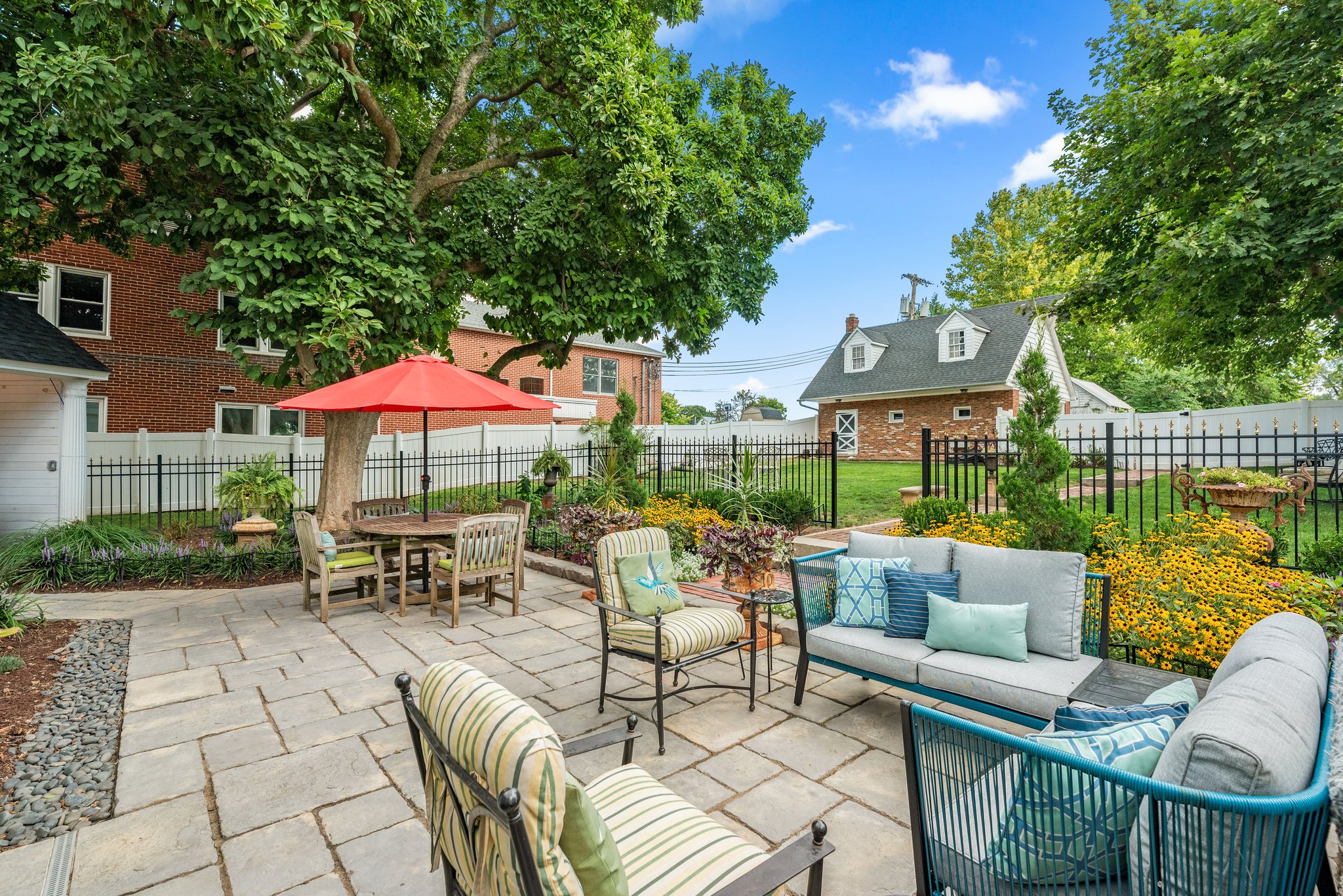 The terrace offers multiple seating areas with wonderful garden views