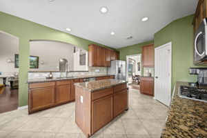 The kitchen features a raised bar, perfect for entertaining guests!