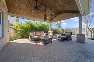 The covered patio is spacious with plenty of space to gather for outdoor fun!