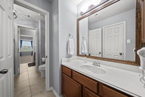 Jack & Jill bathroom with separate vanities and cultured marble countertops.