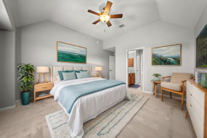 Secondary bedroom upstairs with new carpet (2024), towering ceilings, a ceiling fan, walk-in closet, 2" blinds and a Jack & Jill bathroom!