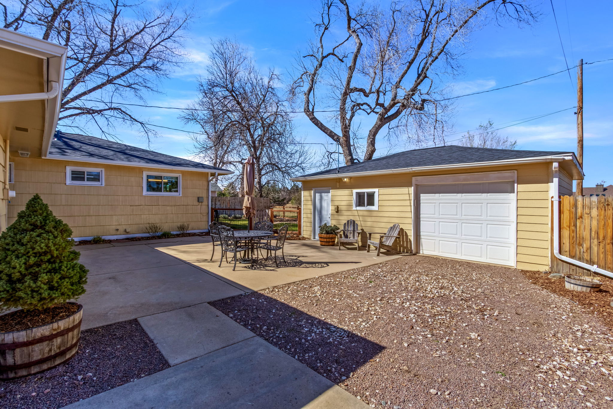 Private patio located on the back of the house connecting the main house to the detached garage and bonus studio room