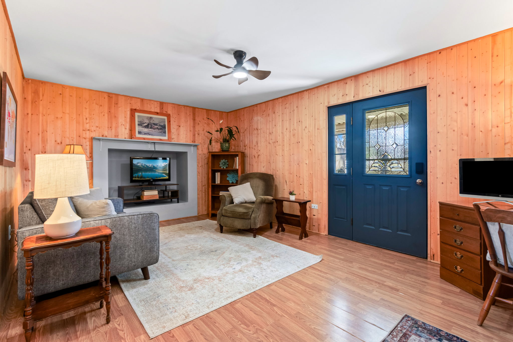 The cozy cabin vibes are fabulous in this separate family room with it's own entrance through the carport.