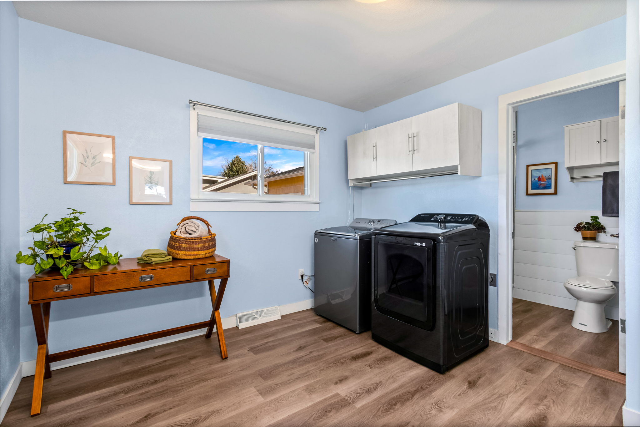 Laundry area attached to the primary bathroom with walk-in shower