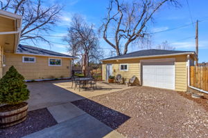 Private patio located on the back of the house connecting the main house to the detached garage and bonus studio room