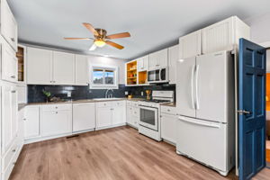 Cabinet space galore! All appliances included. Window looks out onto the back patio, backyard, and private open space