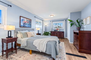 The primary suite offers space for all your favorite furniture and looks out to the backyard. Window coverings allow privacy as well as views with bottom up shades.