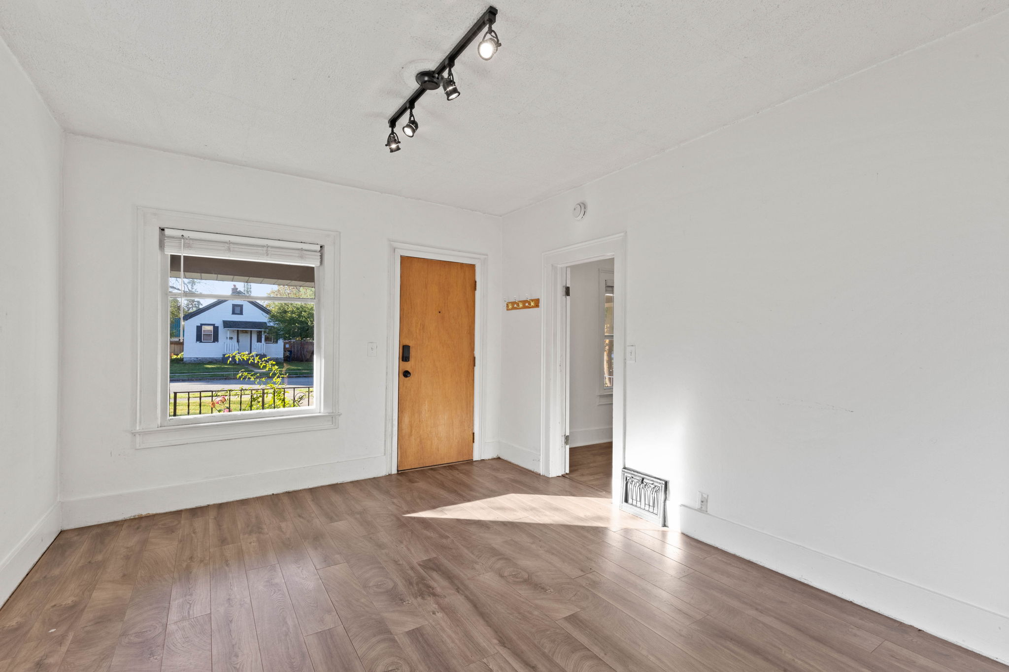 Laminate flooring throughout living space.