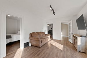 Living Space, Bedroom 2 + Adjoining Office Space and Kitchen beyond.