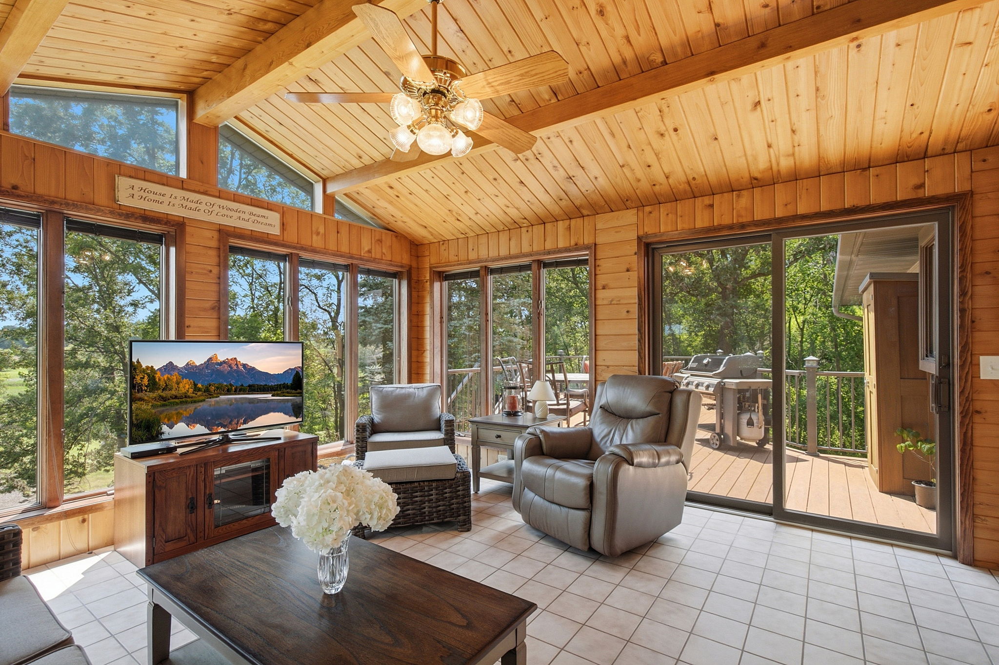 Four-season sunroom leads to oversized, maintenance-free deck.