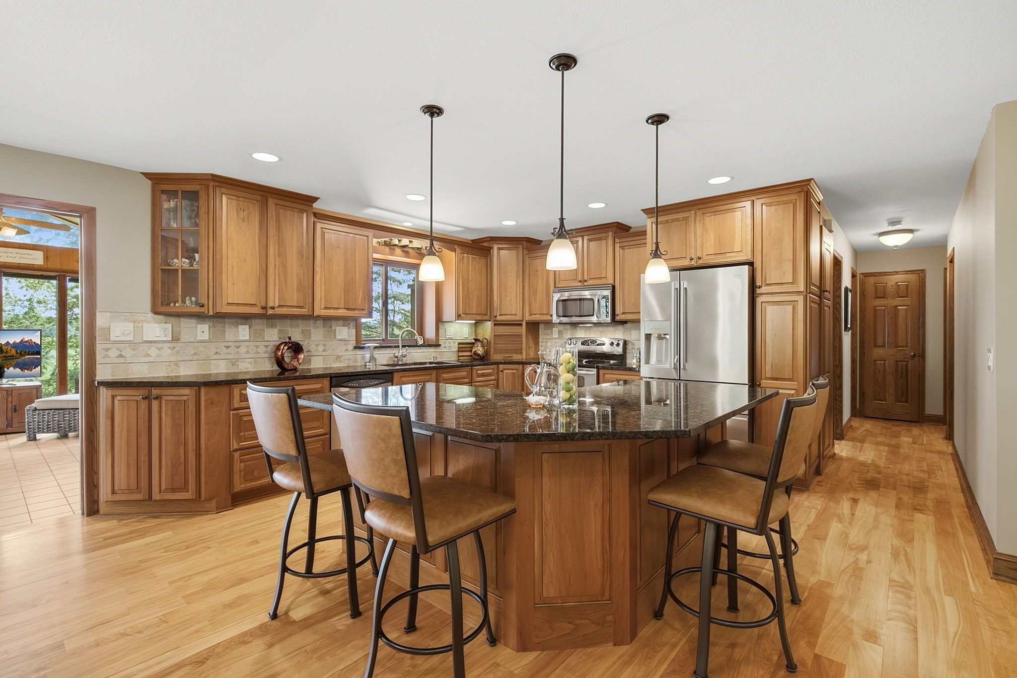 Renovated kitchen with cherry cabinetry, red birch flooring, granite countertops and stainless steel appliances.