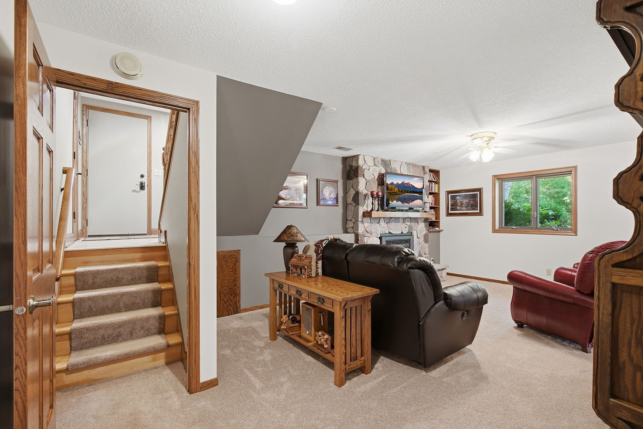 Lower level with gas-burning stone fireplace.
