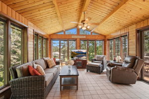 Tongue-and-groove cedar four-season sunroom with Andersen Windows.