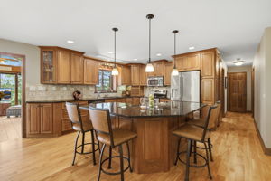 Renovated kitchen with cherry cabinetry, red birch flooring, granite countertops and stainless steel appliances.