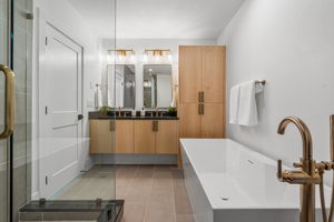 Five piece ensuite with double vanity, quartz counter tops, soaking tub, and walk-in shower.