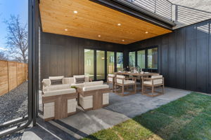 Dine alfresco or enjoy morning coffee with direct access to the kitchen and living room. Virtually staged.