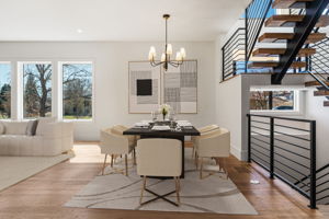 Dynamic chandelier in the Dining area that opens to the kitchen and living room. Virtually staged.
