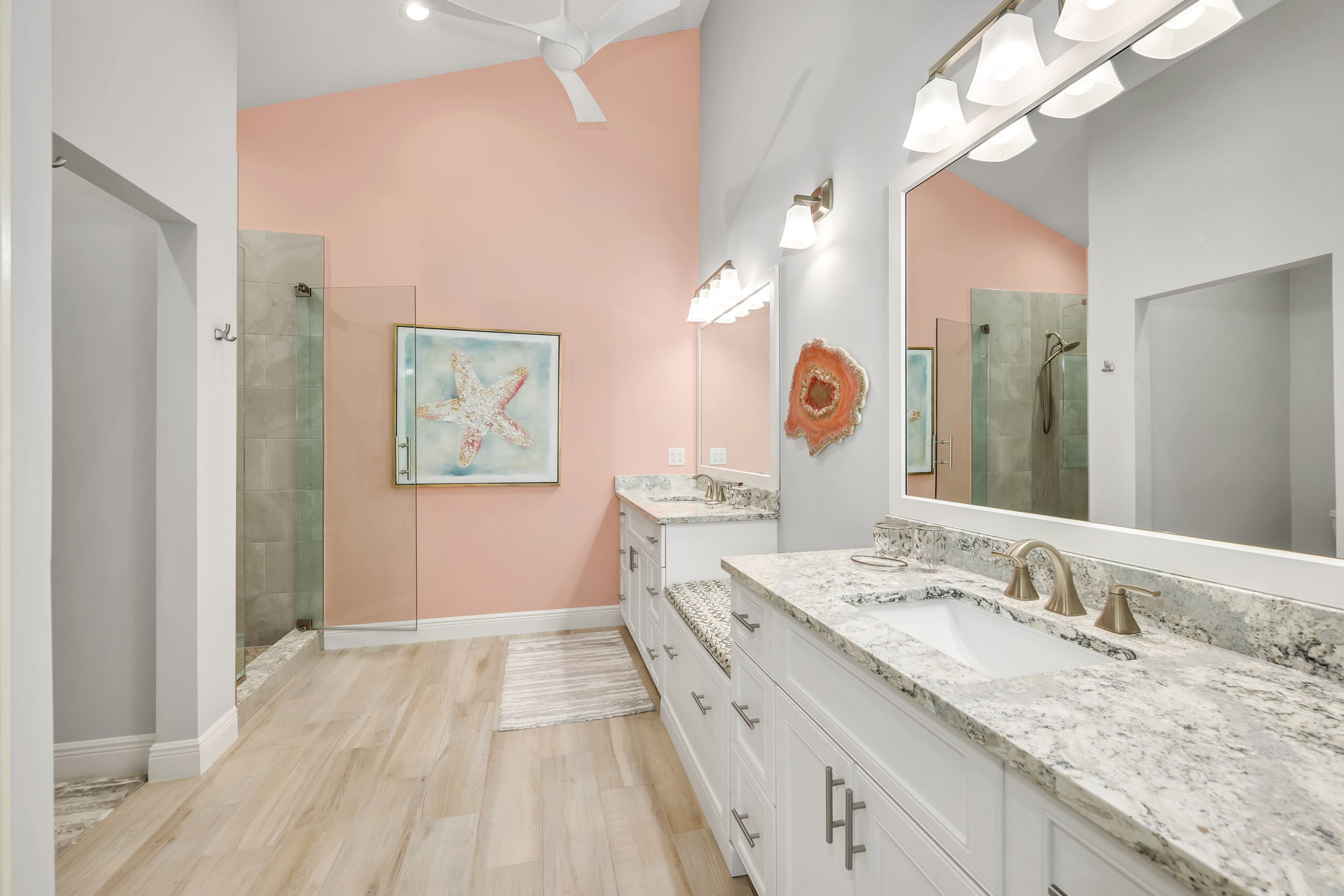 Primary Bathroom has been updated with Quartz countertops, Seamless Glass shower enclosure, and updated tile flooring