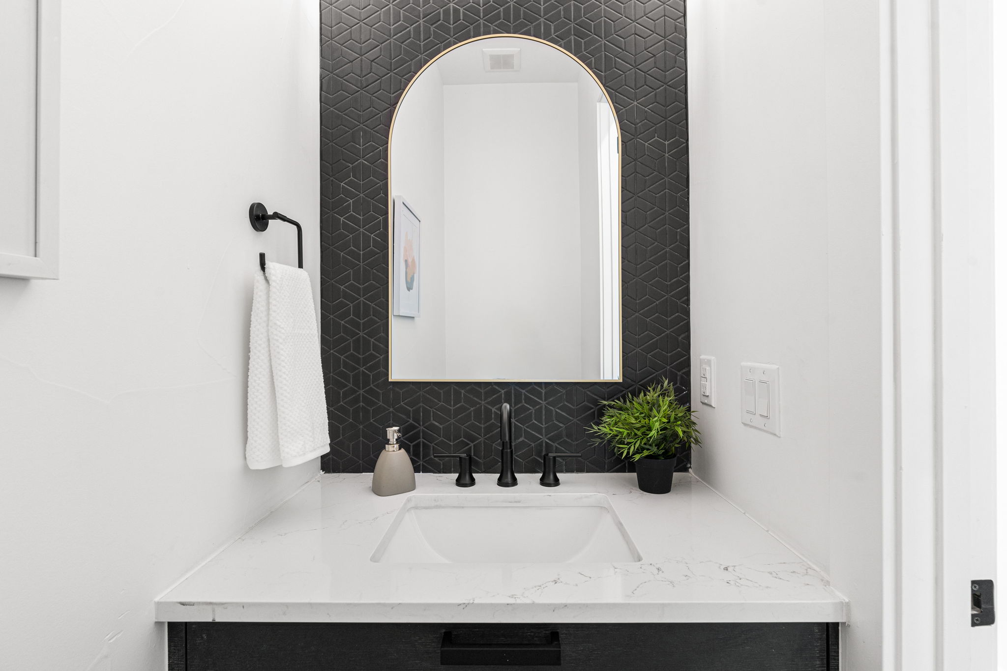 Chic powder room design with a standout tile wall.