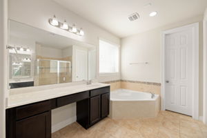 Downstairs-Primary Bathroom. Soaker tub and separate vanities.