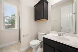 Guest bathroom off kitchen. serves guest bedroom and living room.