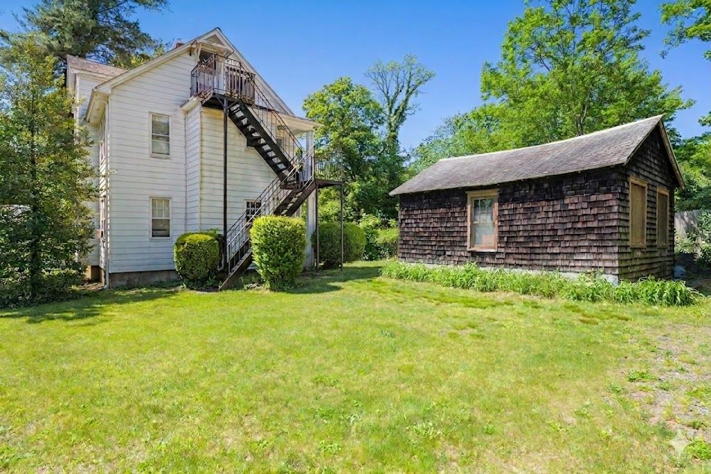 Back yard, fire escape, & brown storage garage