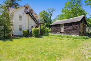 Back yard, fire escape, & brown storage garage