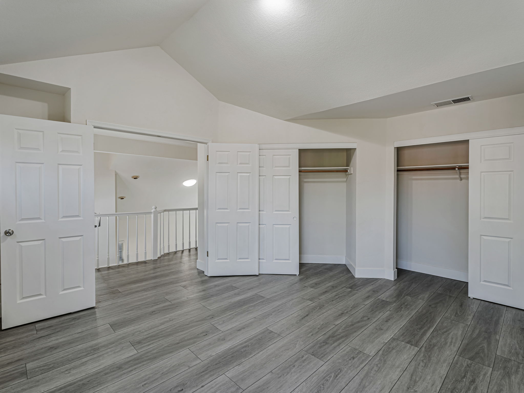 Two closets with double sliding doors.