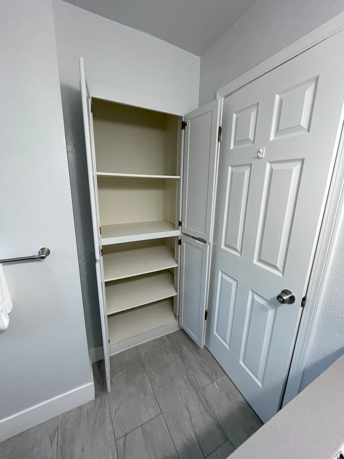 Large linen closet in hall bathroom behind door