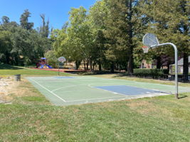 Basketball court with playground beyond