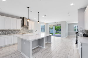 Upscale tile backsplash, high end cabinets, countertops and lighting.