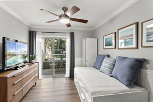 This bedroom has access to a shared balcony and hidden storage!