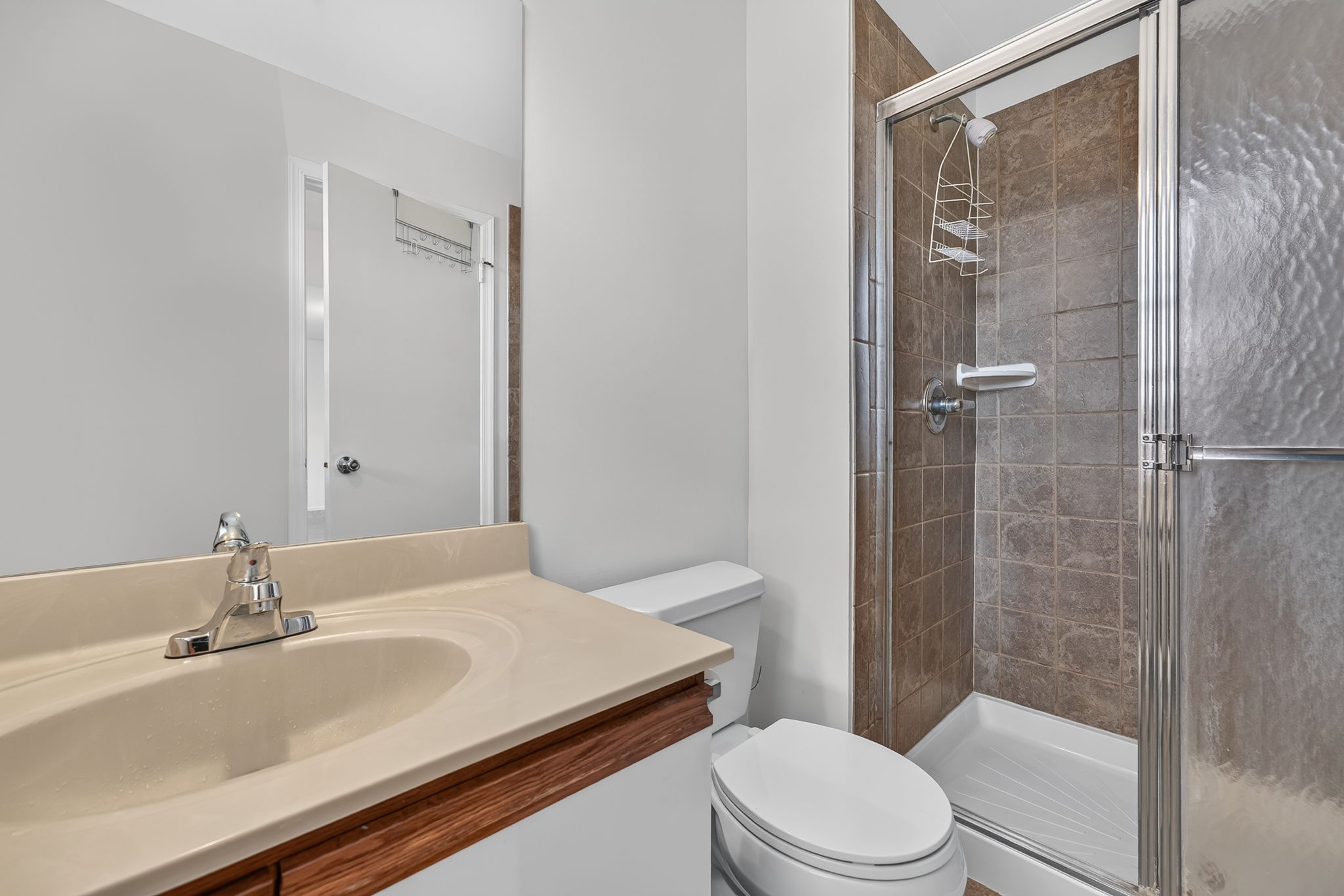 Master Bathroom Plate Glass Mirror Mirrored Medicine Cabinet Molded Top with Single Sink/European Vanity/Cabinet Storage Shower/Updated Ceramic Tile Surround Updated Ceramic Tile Flooring
