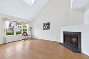 Living Room-Vaulted Ceiling Skylight 3 Side-by-Side Windows/Blinds Woodburning Fireplace LVP Flooring - 2025
