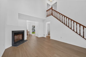 Living Room-Vaulted Ceiling Skylight 3 Side-by-Side Windows/Blinds Woodburning Fireplace LVP Flooring - 2025