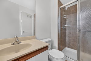Master Bathroom Plate Glass Mirror Mirrored Medicine Cabinet Molded Top with Single Sink/European Vanity/Cabinet Storage Shower/Updated Ceramic Tile Surround Updated Ceramic Tile Flooring