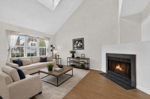 Living Room-Virtually Staged Vaulted Ceiling Skylight 3 Side-by-Side Windows/Blinds Woodburning Fireplace LVP Flooring - 2025