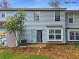 Rear View- Interior Townhouse/2 Levels Brick and Vinyl Sided Exterior Pop-up Attic 1 Car Attached Garage Additional Assigned Parking