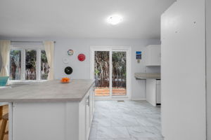 Island with breakfast bar and patio door to back yard.
